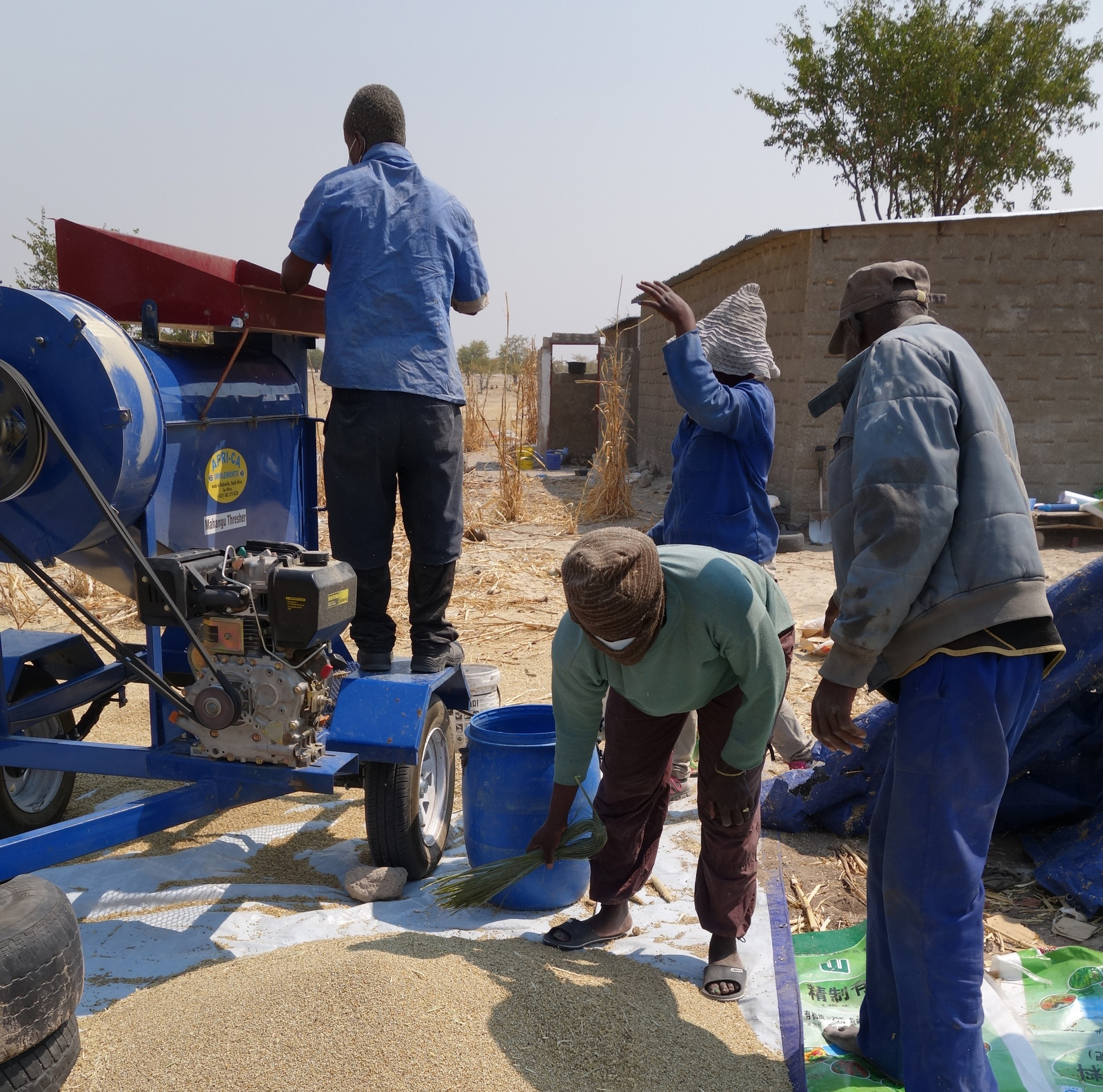 Locals gathered around the diesel thresher in Okathitu, Namibia.